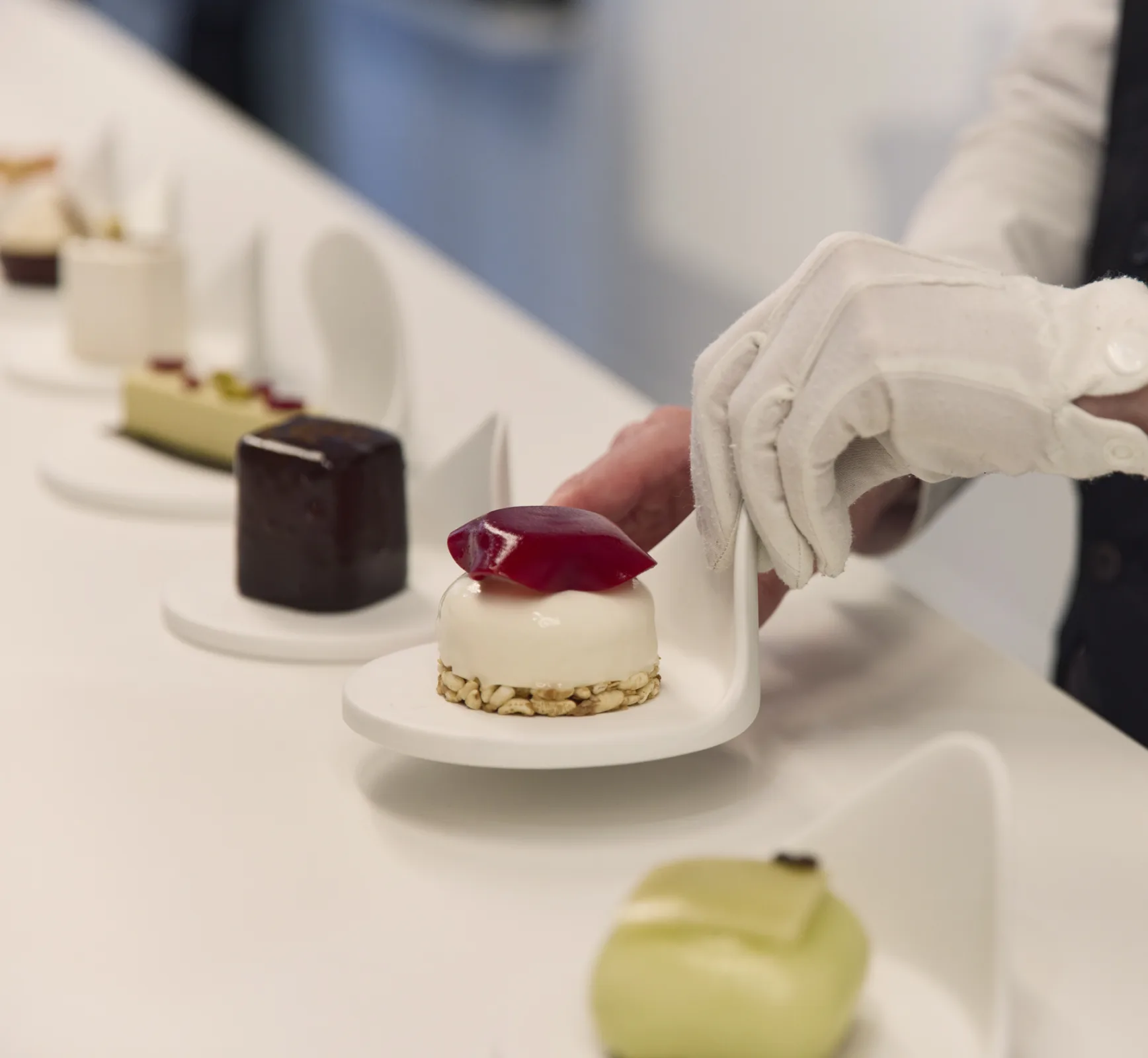 Petits gâteaux, placed by a gloved hand